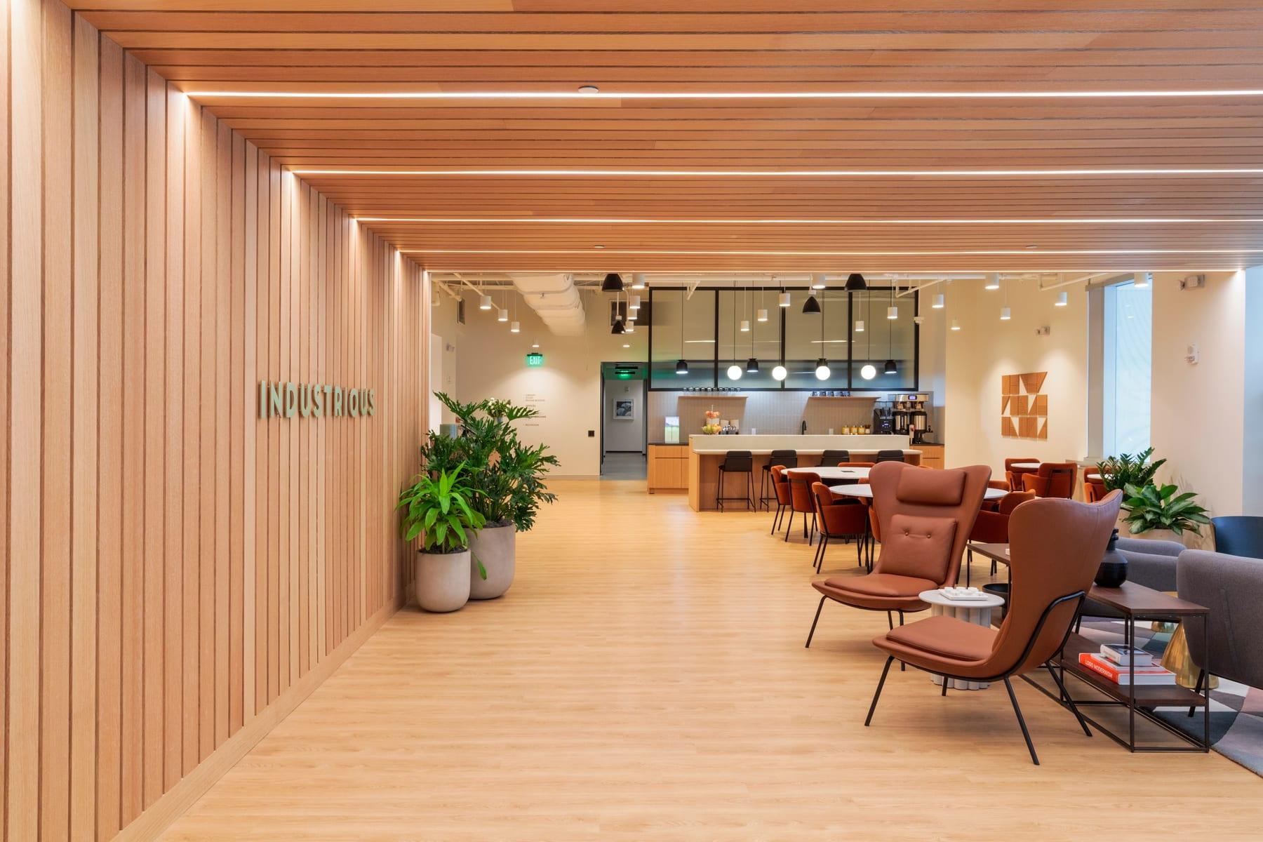 The Industrious coworking space: wood-panelled lounge and kitchen area
